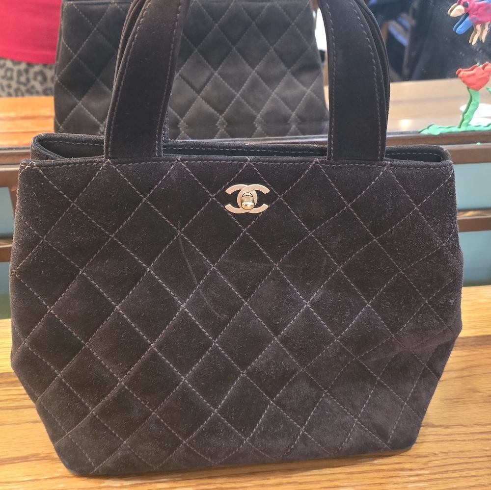 A beautiful CHANEL brown suede quilted top handle bag!
